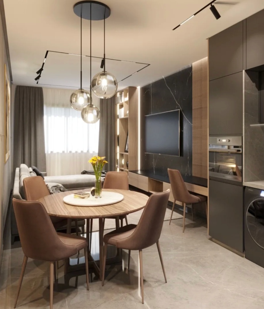 Coin repas avec table ronde en bois, suspensions globes fumés et mur en marbre noir